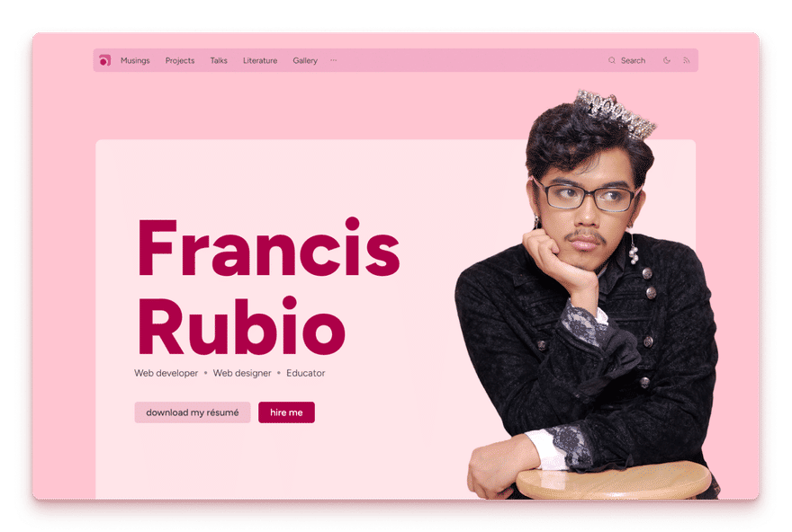 Screenshot of previous website showing an overall pink aesthetic and a focus on myself wearing an 1800s black coat, pearl earrings, and a jeweled crown.