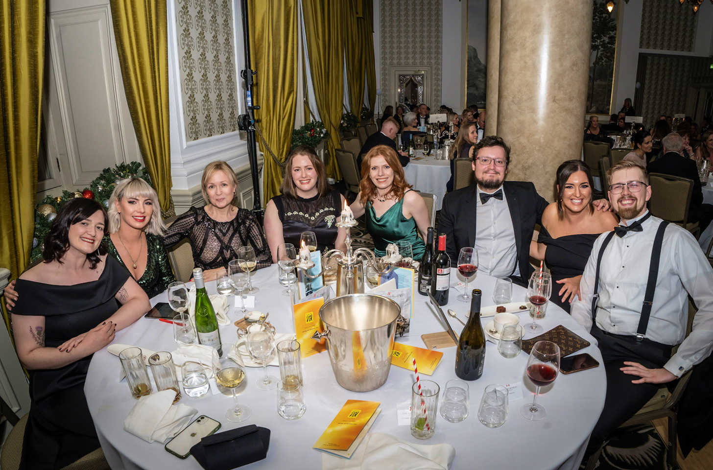 Team 8MS round a table at a Cancer Card Charity event.