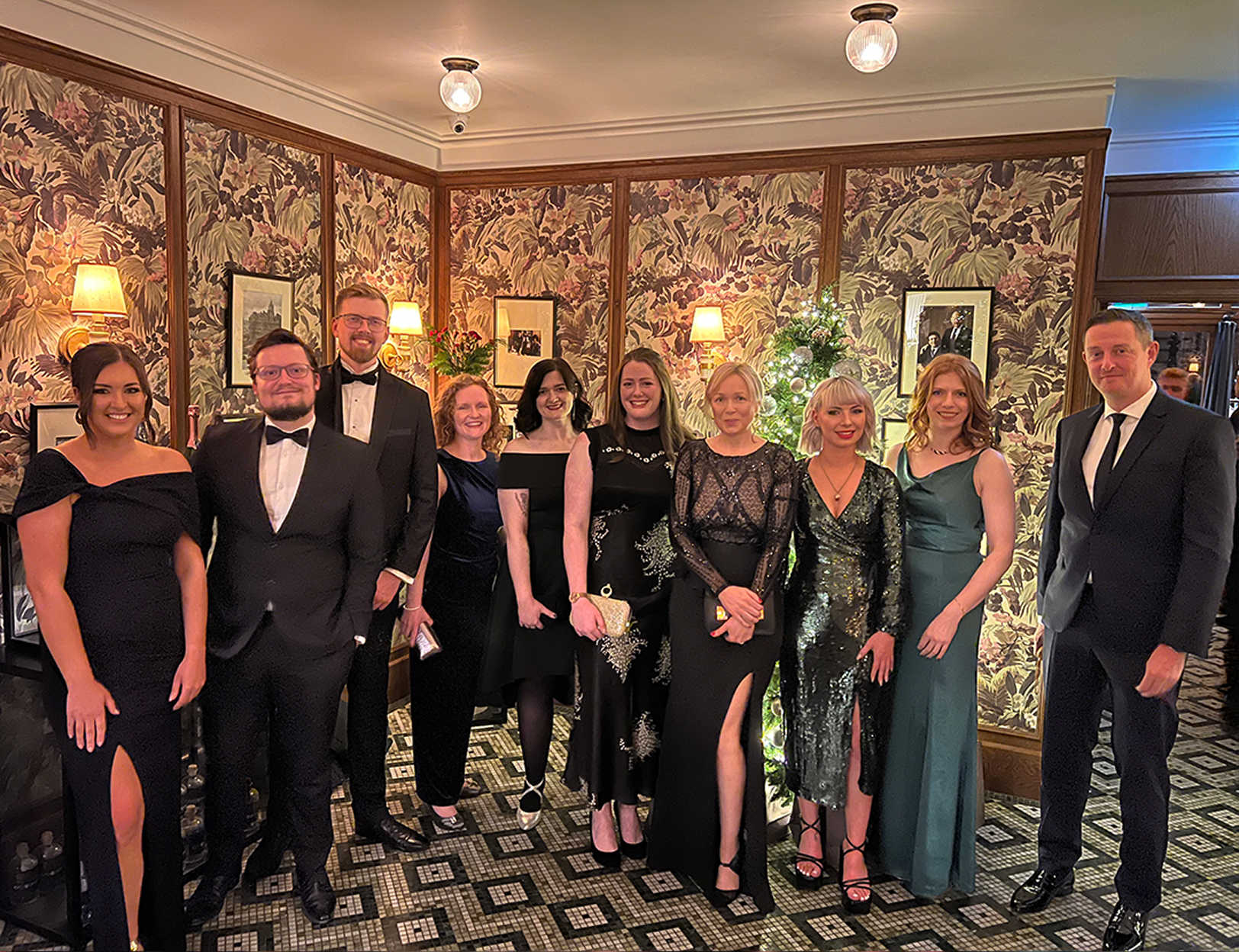 Team 8MS pose for a group photo at a black tie event.