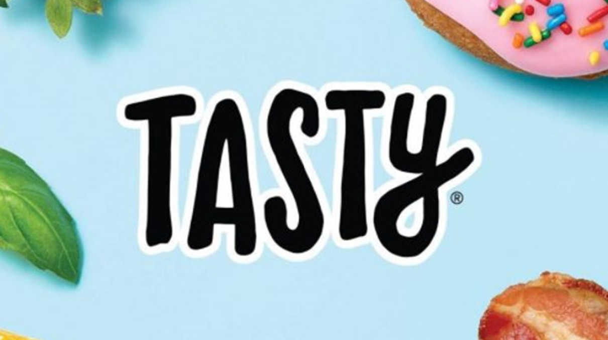 A blue background featuring the word 'Tasty' in the centre, with leaves and pastries scattered around the edges.