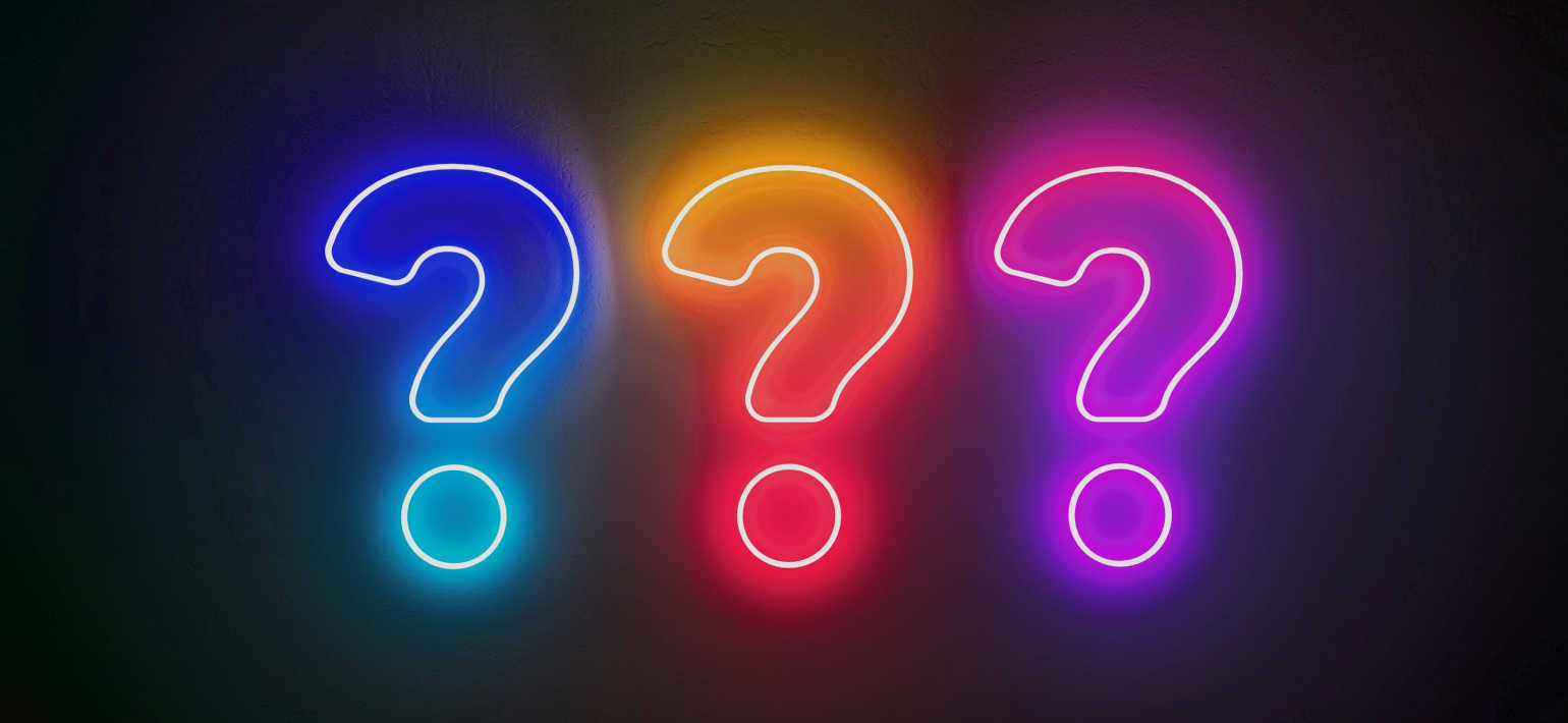 Three neon question marks, one blue, one orange and one purple, against a black background.