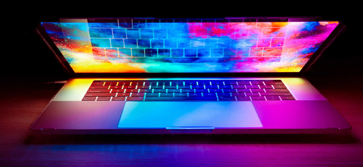 A colourful image of a laptop that is partially open.