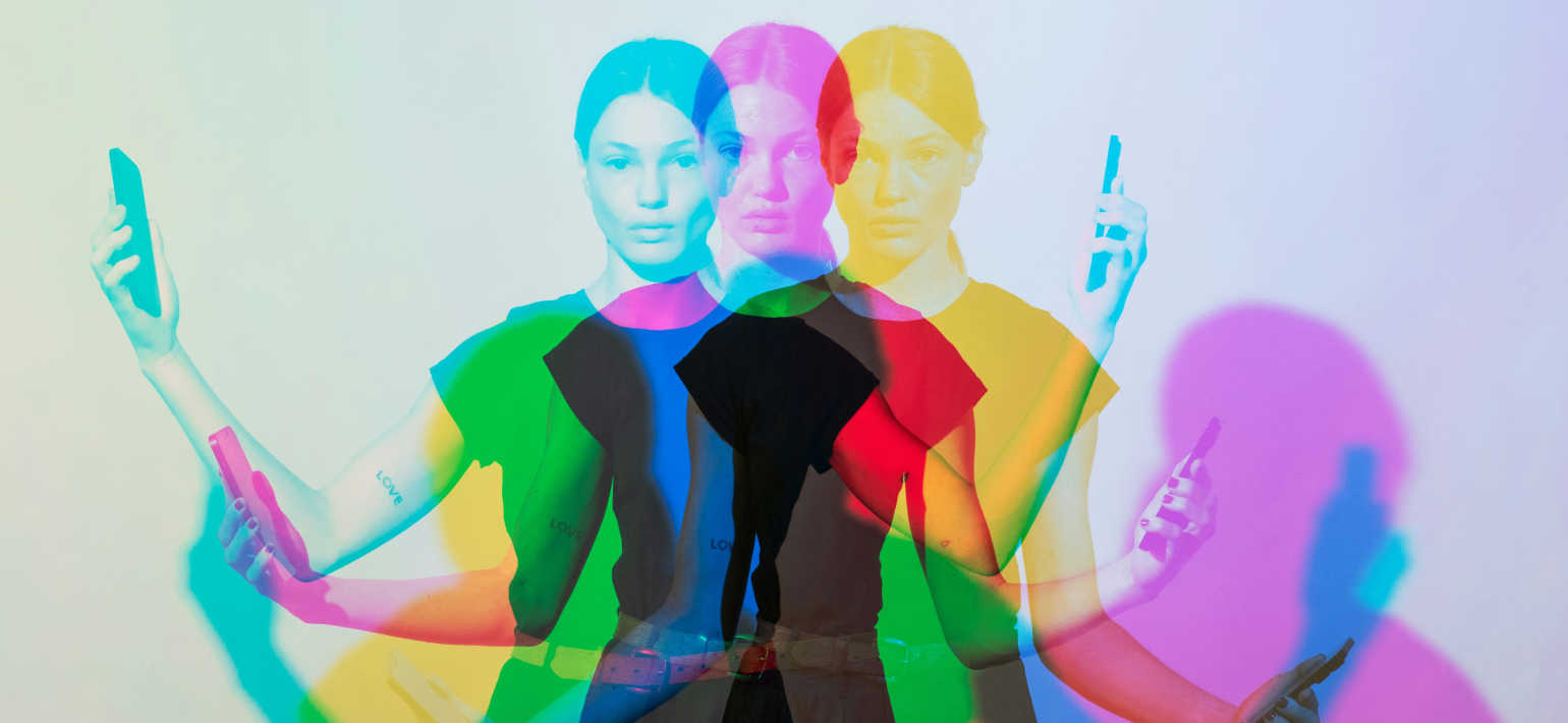 A psychedelic image of a woman with multi-coloured shadows on both sides of her.