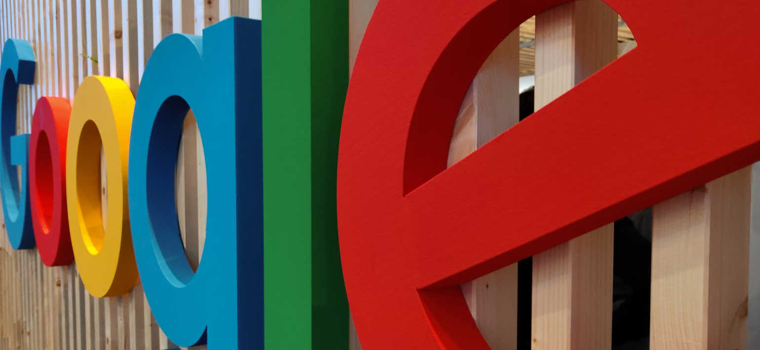A close up image of the Google logo on a building wall.