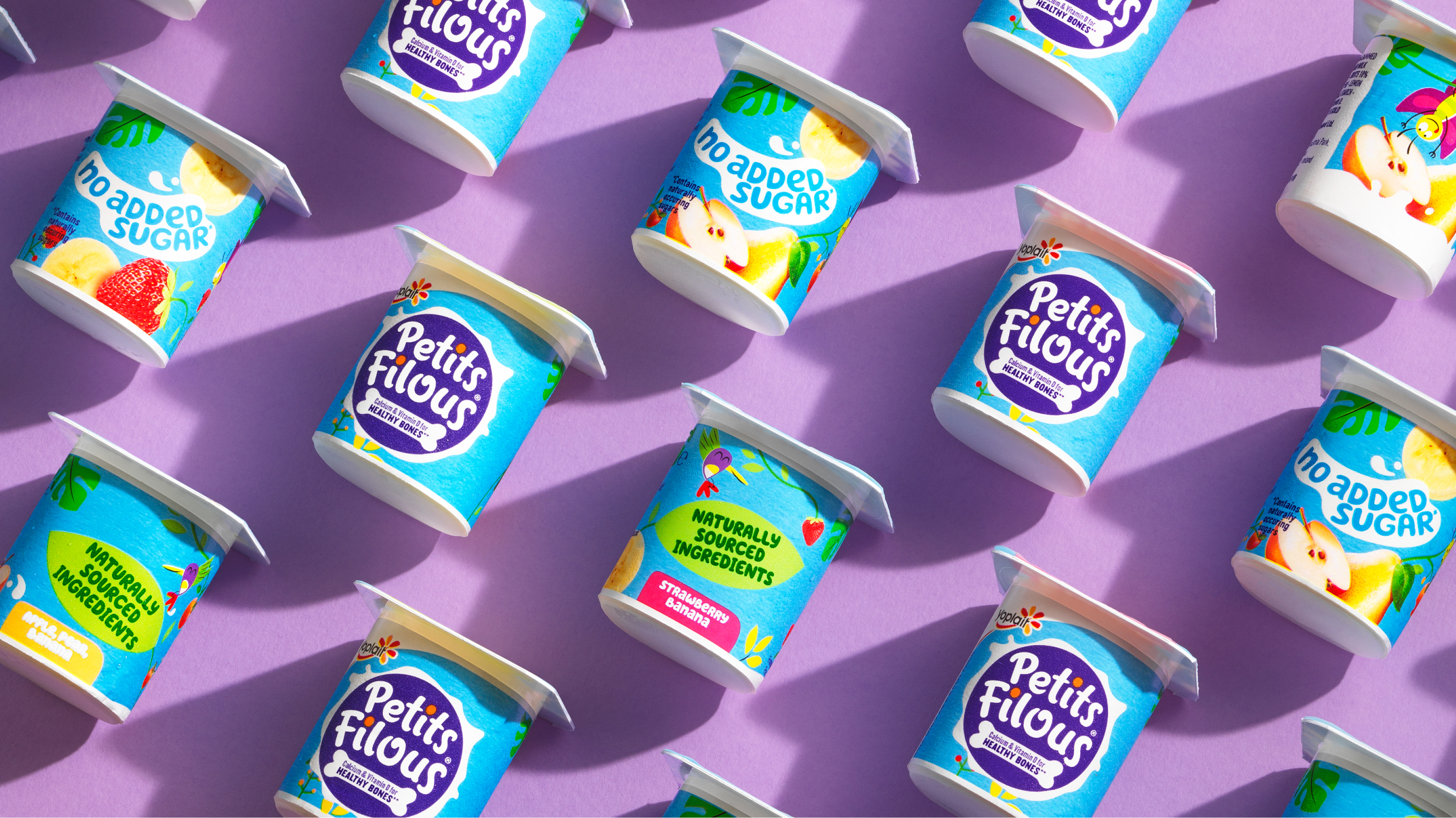 Petit Filous yoghurt tubs arranged to show off their branding and design.