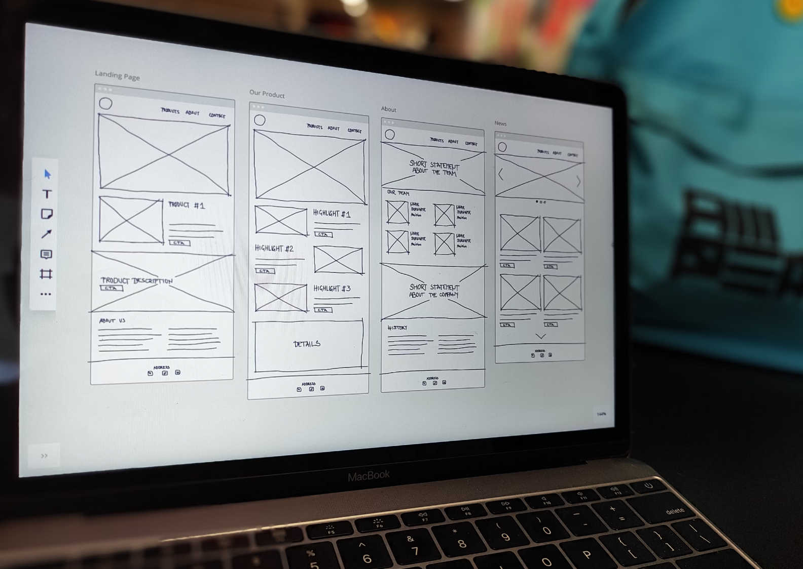 A laptop screen displaying a wireframe design for a website.