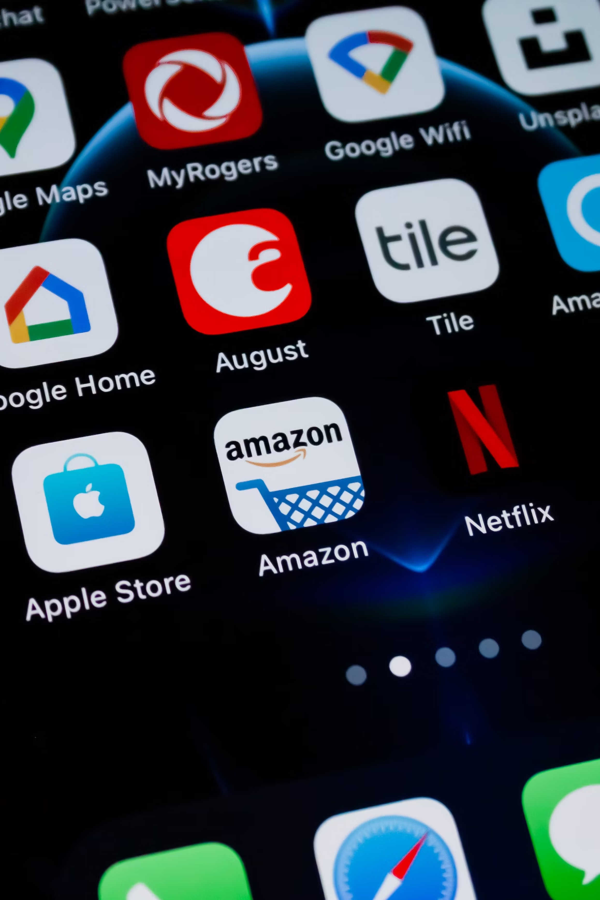Close-up of a smartphone screen displaying popular app icons including Amazon, Netflix, Apple Store, Google Home, and Tile.