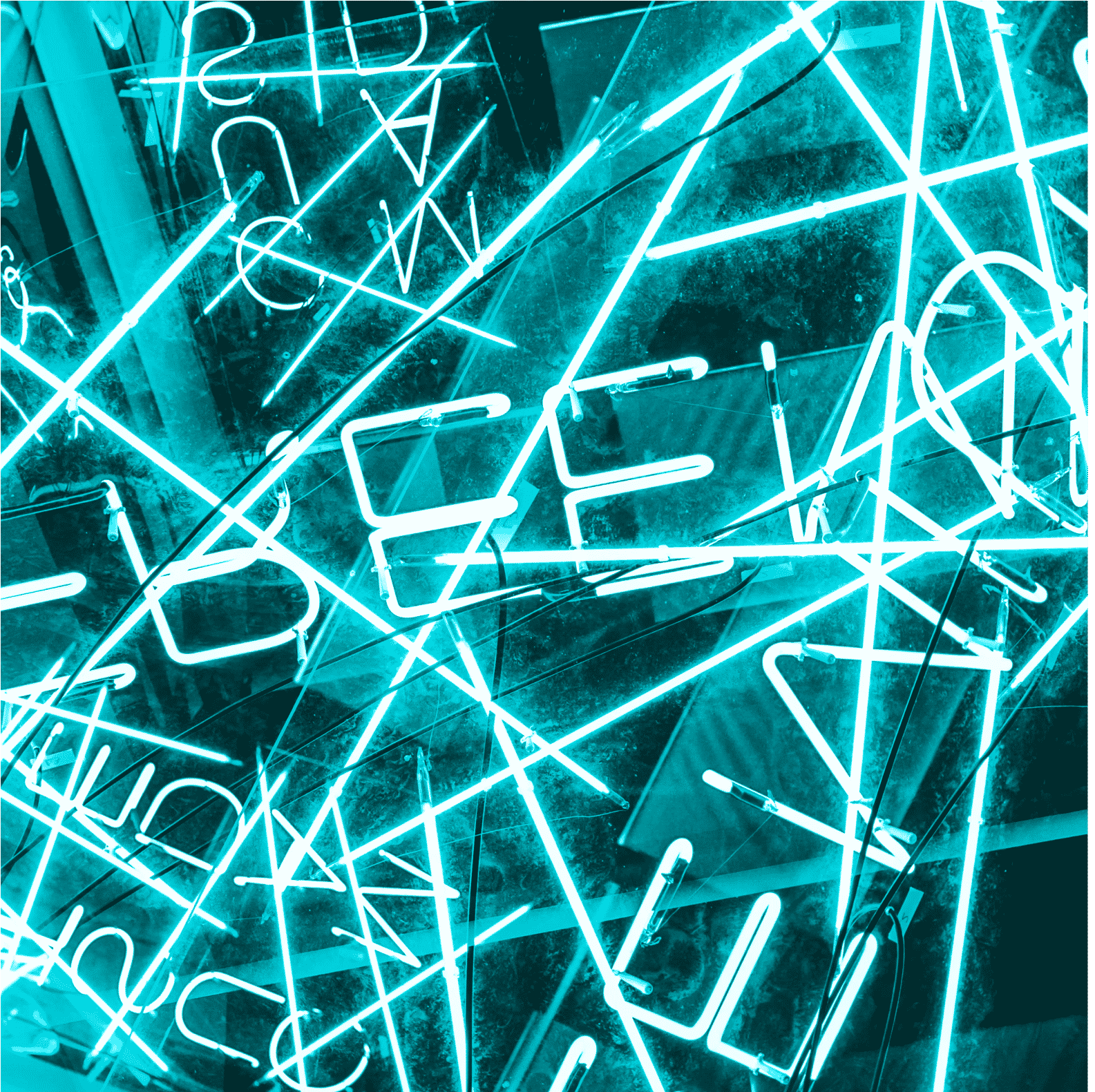 Abstract image of various neon letters overlayed and reflected on one another.