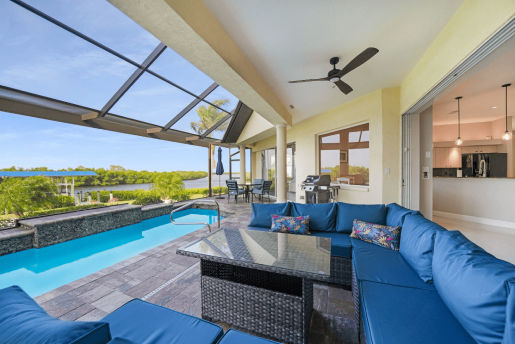 Outdoor Swimming Pool View in a Covered Outdoor Patio With Blue Couch Set