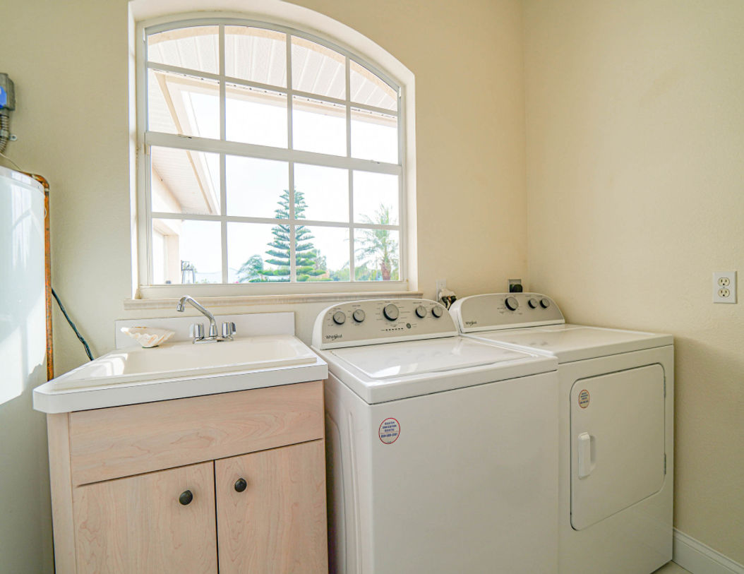 White Diswasher Beside Beautiful Peach Color Sink