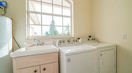 White Diswasher Beside Beautiful Peach Color Sink