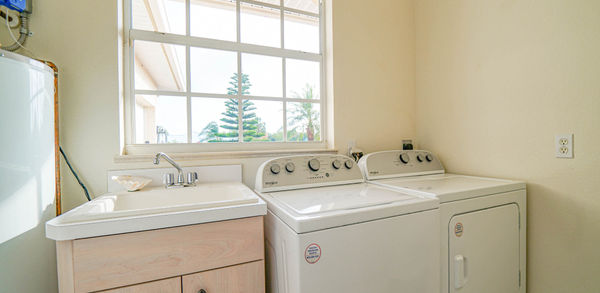 White Diswasher Beside Beautiful Peach Color Sink