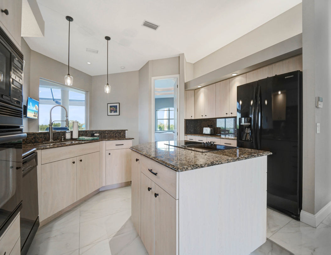 Modern Kitchen Area With Beautiful Big Black Refrigerator and Microwave Oven