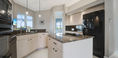 Modern Kitchen Area With Beautiful Big Black Refrigerator and Microwave Oven