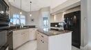 Modern Kitchen Area With Beautiful Big Black Refrigerator and Microwave Oven