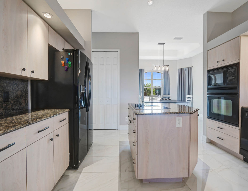 Elegant Kitchen Area With Black Black Refrigerator and Microwave Oven