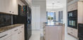 Elegant Kitchen Area With Black Black Refrigerator and Microwave Oven
