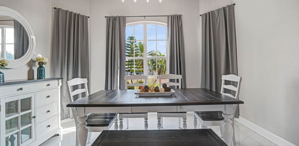 Balck abd White Wooden Dining Table With Beautiful Decoraton on Top