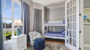 Children’s Bedroom With  Bunk Bed Covered in Stripe Blue Bedding