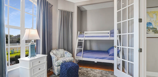 Children’s Bedroom With  Bunk Bed Covered in Stripe Blue Bedding