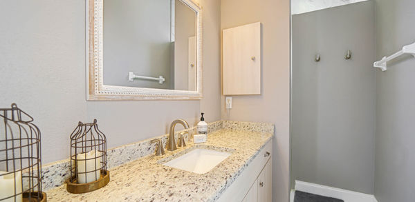 Framed White Mirror in a White and Gray Bathroom