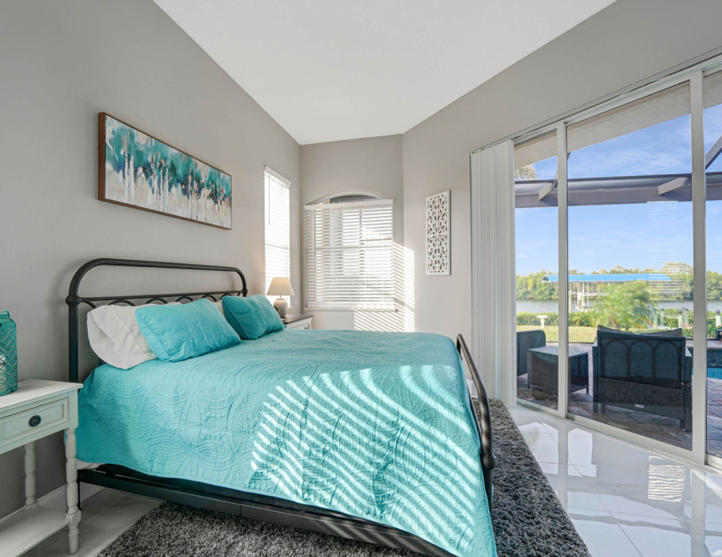 Big Bedroom Covered in Sky Blue Bedding Near Pool Area