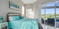 Big Bedroom Covered in Sky Blue Bedding Near Pool Area