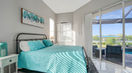 Big Bedroom Covered in Sky Blue Bedding Near Pool Area