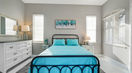 Bedroom With White Blind Curtains and Double Bed Covered in Sky Blue Bedding