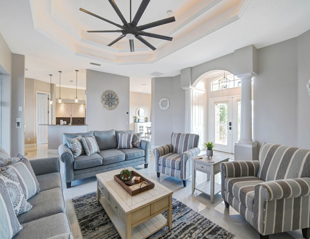 Wide Beautiful Living Room With Grey and Stripe Couch Set