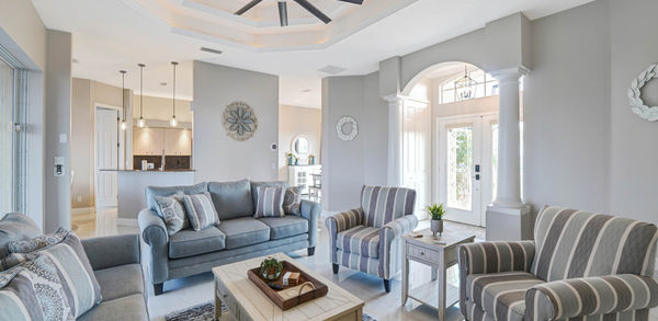 Wide Beautiful Living Room With Grey and Stripe Couch Set