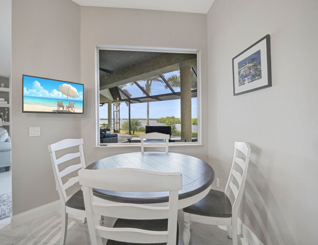 White and Brown Kitchen Table With Beautiful Paintings