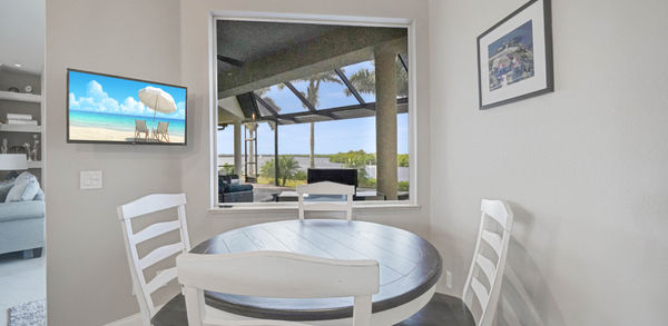 White and Brown Kitchen Table With Beautiful Paintings