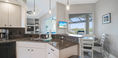 Clean Kitchen With Three Hanging Lights
