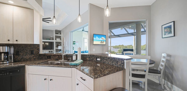 Clean Kitchen With Three Hanging Lights