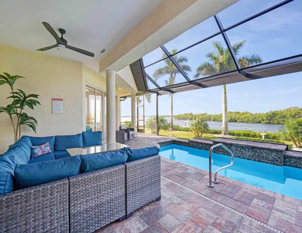 Blue Covered Lounge Couch Near Pool Area