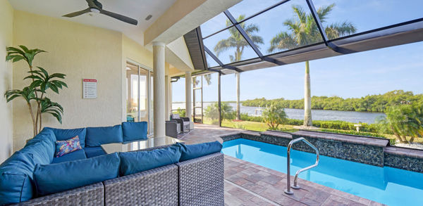 Blue Covered Lounge Couch Near Pool Area
