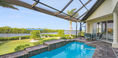 Modern Outdoor Pool Area With Blue Table Set Near Backyard