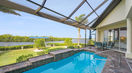 Modern Outdoor Pool Area With Blue Table Set Near Backyard