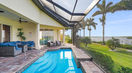 Swimming Pool View With Two Outdoor Chairs and Blue Covered Couch Set