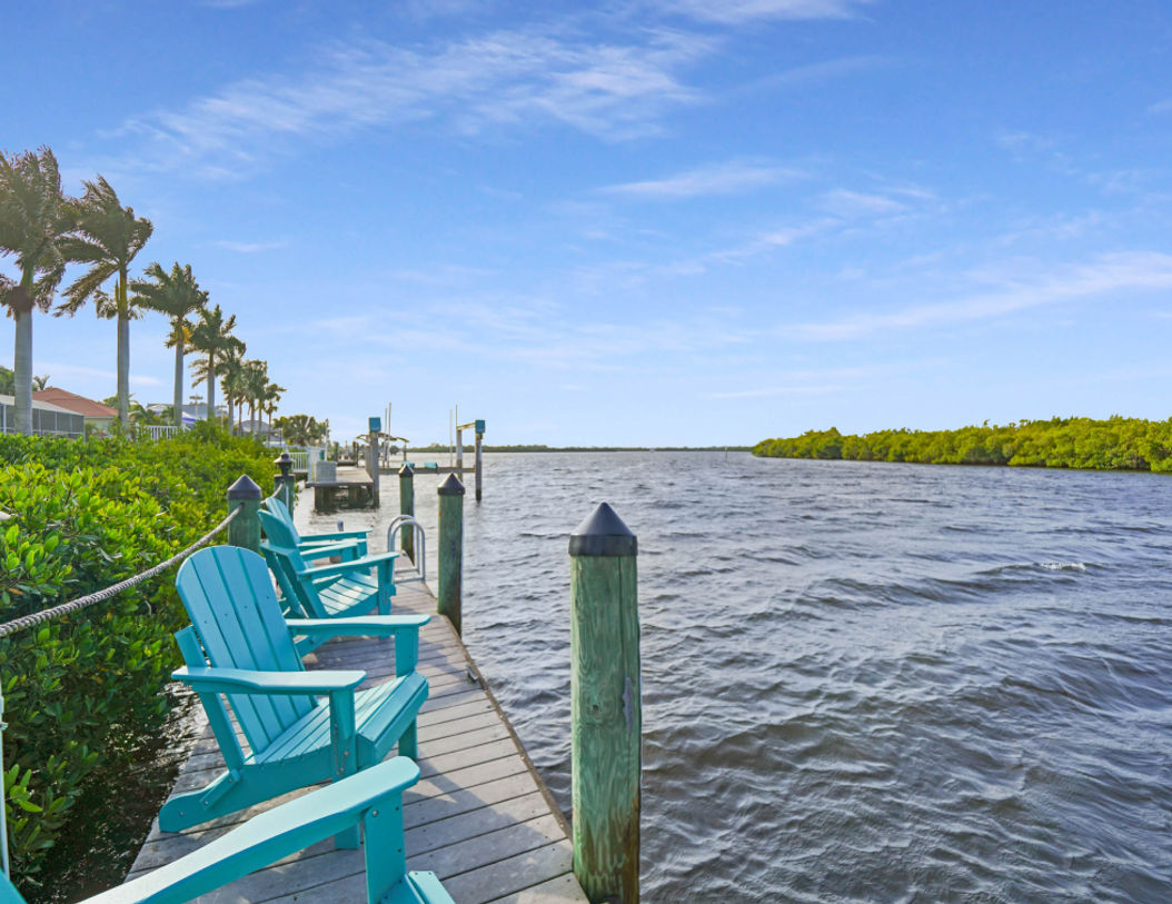 Green Wooden Chairs in Waterfront Side
