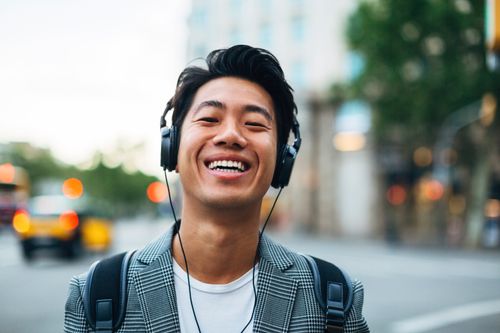 A young man wearing a headset in an outdoor environment