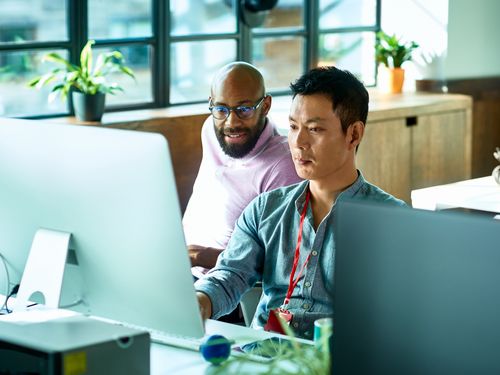 Developers in an office reviewing code for security issues