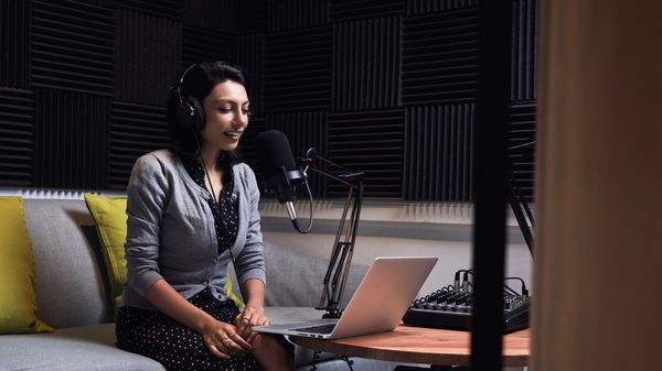 Agent using customer experience enhancement solutions with her computer, microphone, and headset