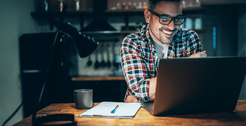 man smiling at computer