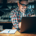 man smiling at computer