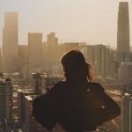 A female business employee looking at the buildings in front of her