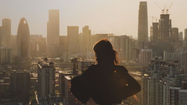 A female business employee looking at the buildings in front of her