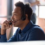 Man in Blue Dress shirt on Headset