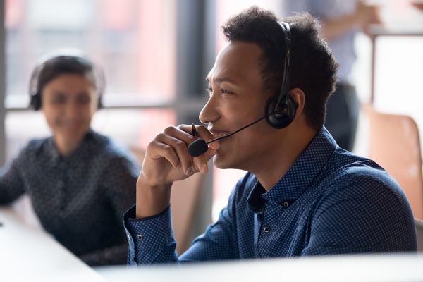 Man in Blue Dress shirt on Headset